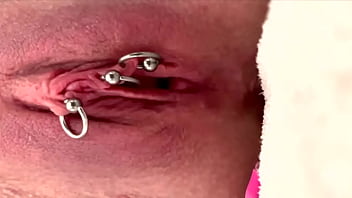 Pulling and stretching my pierced clit and pushing my pussy to pee