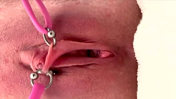 Pulling and stretching my pierced clit and pushing my pussy to pee