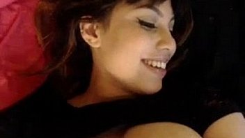 Camgirl showing her big tits while she smile