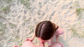 Sucking off my best friend at the public beach and taking cumshot on my pretty face