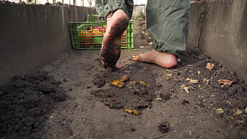 Dirty feet crushing vegetables outdoors