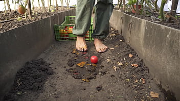 Dirty feet crushing vegetables outdoors