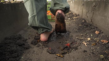 Dirty feet crushing vegetables outdoors