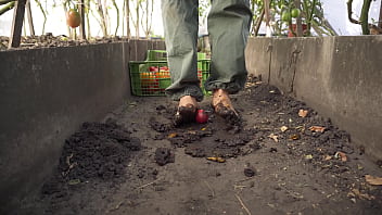 Dirty feet crushing vegetables outdoors