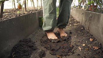 Dirty feet crushing vegetables outdoors