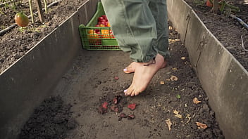 Dirty feet crushing vegetables outdoors
