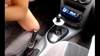 Busty masturbates with the hand brake in the car