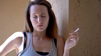 Brunette smoking tease with intense eye contact