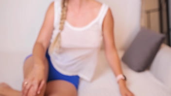 Flexible babe masturbates on a soft couch