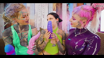 Two dominas gang up on goth chick to fill her holes with toys and make her cum