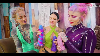 Two dominas gang up on goth chick to fill her holes with toys and make her cum