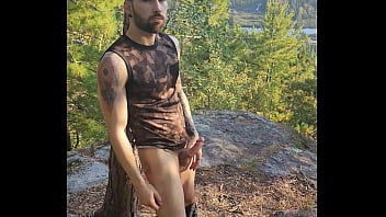 Bearded tattooed hunk blowing a load on the mountain