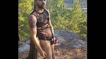 Bearded tattooed hunk blowing a load on the mountain
