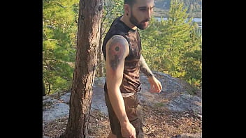 Bearded tattooed hunk blowing a load on the mountain