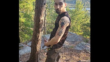 Bearded tattooed hunk blowing a load on the mountain