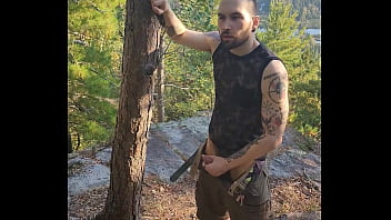 Bearded tattooed hunk blowing a load on the mountain