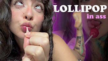 Girl with split tongue licks a lollipop and puts in ass
