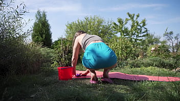 Sexy wife cleaning yoga mat and flashes butt under skirt outdoors