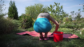 Sexy wife cleaning yoga mat and flashes butt under skirt outdoors