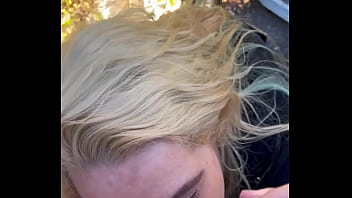 Blonde streetwalker takes a facial in public