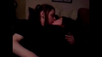 Two hot lesbian kissing and touching on the couch