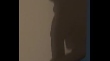 The shadow reflects her sucking his cock