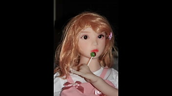 Small busty sex doll posing in pink