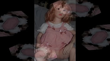 Small busty sex doll posing in pink