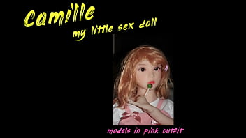 Small busty sex doll posing in pink