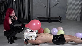 A man scared by balloons bursting and a laughing mistress