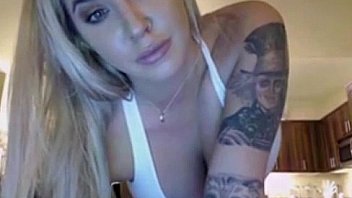 Sexy tattooed blonde demonstrates her perfect body