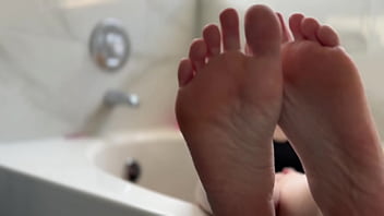 Big tit blonde oils her soles for you