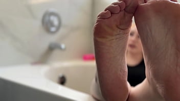 Big tit blonde oils her soles for you