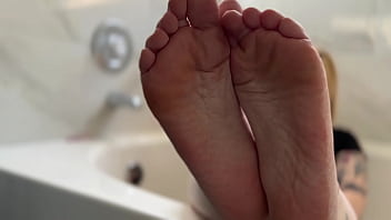 Big tit blonde oils her soles for you