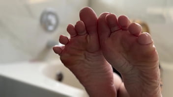 Big tit blonde oils her soles for you