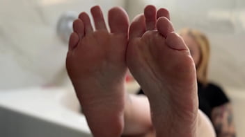 Big tit blonde oils her soles for you