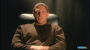 An attractive brunette dressed in provocative lingerie is engaging in a pleasurable sexual encounter on the sofa