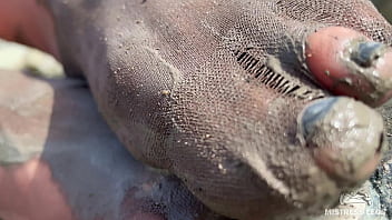 Dirty feet in pantyhose teasing outdoor