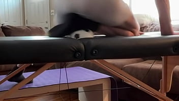 Groin stretch in tight spandex shorts with mini football soccer ball on stool and table slowed down time lapse