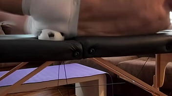 Groin stretch in tight spandex shorts with mini football soccer ball on stool and table slowed down time lapse