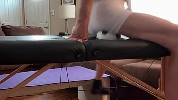 Groin stretch in tight spandex shorts with mini football soccer ball on stool and table slowed down time lapse