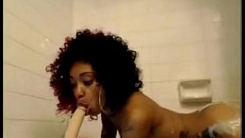 Ebony fucks and sucks dildo