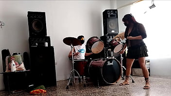 They play the drums for her she dances stripping and showing her ass