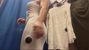 A sexy girl changes clothes in a public place