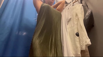 A sexy girl changes clothes in a public place