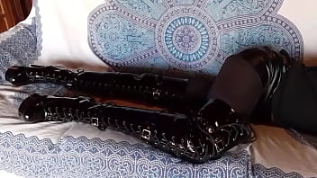 Total black with fishnets pantyhose and boots over the knee