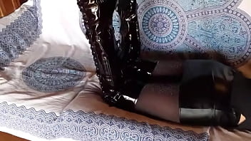 Total black with fishnets pantyhose and boots over the knee