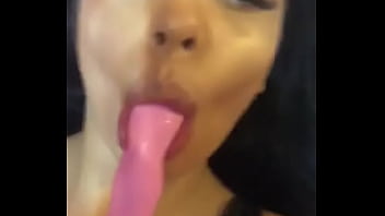 Brunette playing with dildo in mouth