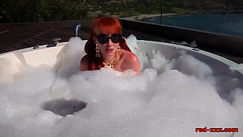 British redhead plays with her pussy outside in the hottub