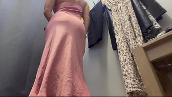 A sexy woman with big breasts and a big ass tries on clothes
